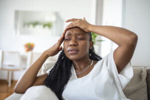 woman suffering from chronic pain and menopause symptoms - hormone imbalance