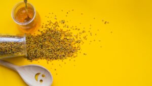 bee pollen, honey and a wooden spoon
