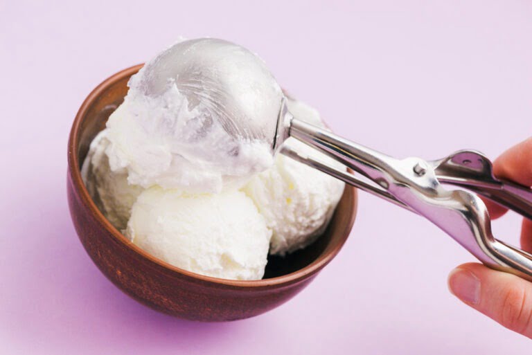 vanilla keto ice cream being scooped into a bowl