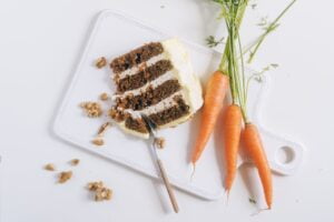 a slice of vegan gluten-free carrot cake with carrots