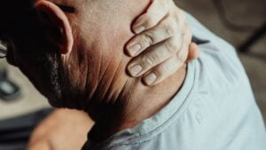Close-Up Photo of a Man Having a Neck Pain | Neck hump | dowager's hump or buffalo hump