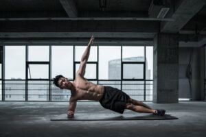 Man doing side plank strengthening weak core muscles