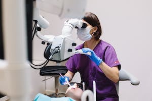 Woman in Purple Scrub Using a Dental Equipment in Examining a Patient | Placeholder for Cigna Dental Insurance | Florida | Humana Dental Insurance