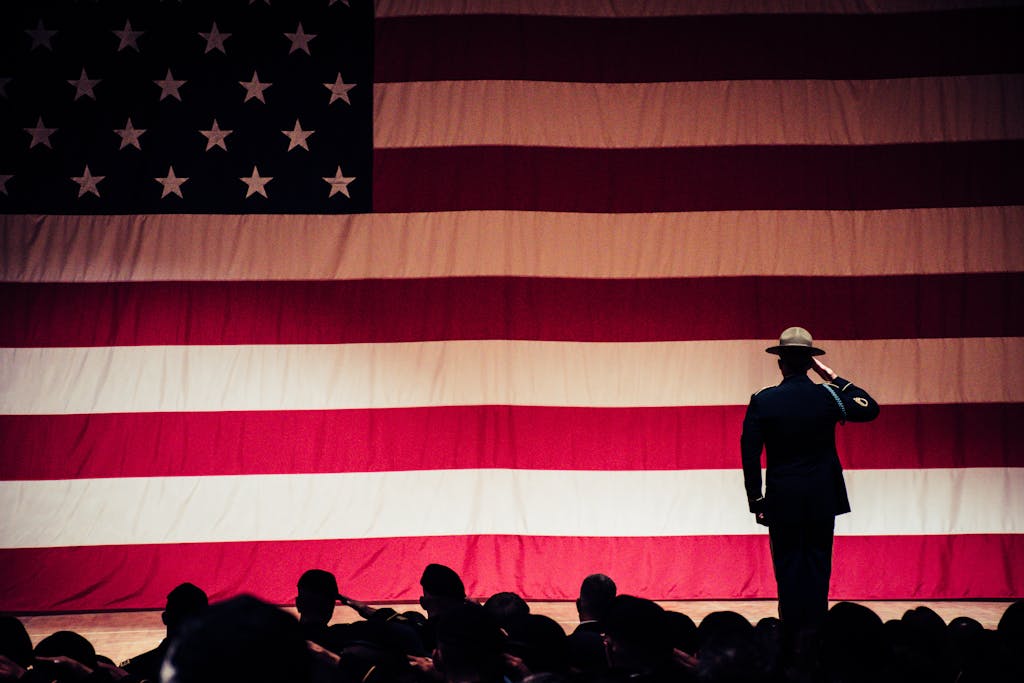 Man Standing On Stage Facing An American Flag | placeholder for Chronic Fatigue Syndrome VA Rating