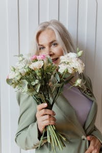 Woman in Green Blazer Holding Flowers | placeholder for 4 ingredients Anti-aging formula