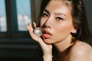 A Beautiful Woman Holding a Moonstone while Looking at the Camera | skincare secret