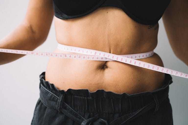 Photo of a Tape Measure on a Person's Waist | Is Intermittent Fasting the Secret to Rapid Weight Loss? | Body Fat Percentage