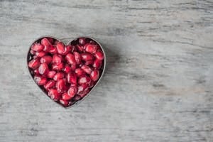 Silver Heart Bowl Filled of Red Pomegranate Seeds | 10 Anti-Aging Superfoods