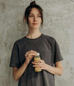 Woman Holding A Bottle Of Juice | Is Psyllium Husk the Safer and More Affordable Ozempic Alternative No One Talks About? | Bloat & Fatigue BE GONE! This "Instant Reset" Detox Drink Flattens Your Belly & Boosts Energy FAST