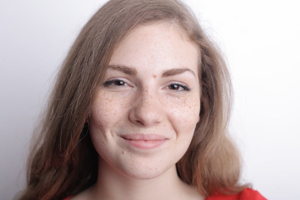 Close-up portrait of a smiling young woman with freckles and natural beauty. | Dark Spots, Who? The 2-Product Routine That Changed My Skin in a Month