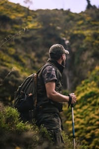 Man with hiking gear explores lush forest landscape, embodying adventure and nature. | From Fat to Fuel: How Metabolic Flexibility Boosts Energy and Longevity