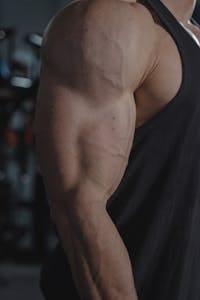 Detailed image of a muscular arm displaying veins, ideal for fitness and health themes. | Target Your Long Head Tricep with These 7 Must-Do Exercises
