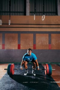 man doing a deadlift Certified Trainer Reveals the Most Overlooked Exercise You Should Be Doing | hip hinge