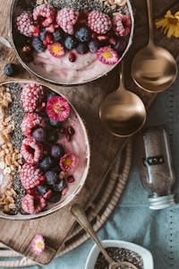 Delicious smoothie bowls topped with fresh berries, perfect for a healthy breakfast.