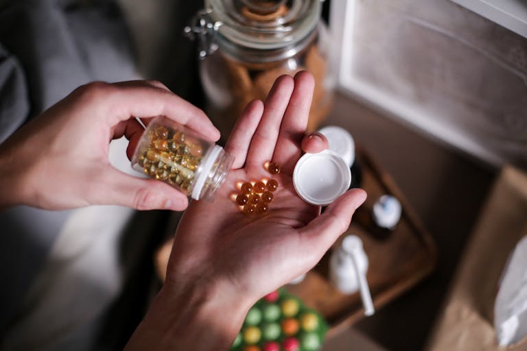 Hands carefully holding supplement capsules, representing health and wellness. | Doctors Say: This is the Best Time to Take Vitamin D Supplements for Maximum Benefits