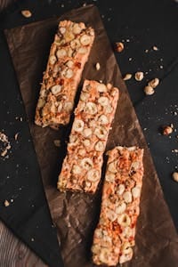 Top view of homemade nut muesli bars on parchment paper, a perfect healthy snack. | 10 Protein Bars You Should Steer Clear Of—Don’t Waste Your Money!
