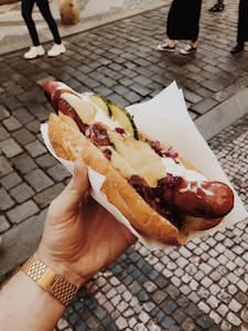 Enjoy a delicious hotdog in Prague showcasing traditional Czech street food flavors. | 10 Processed Meats Wrecking Your Gut and Slowing Your Metabolism (Cut Them Out ASAP)