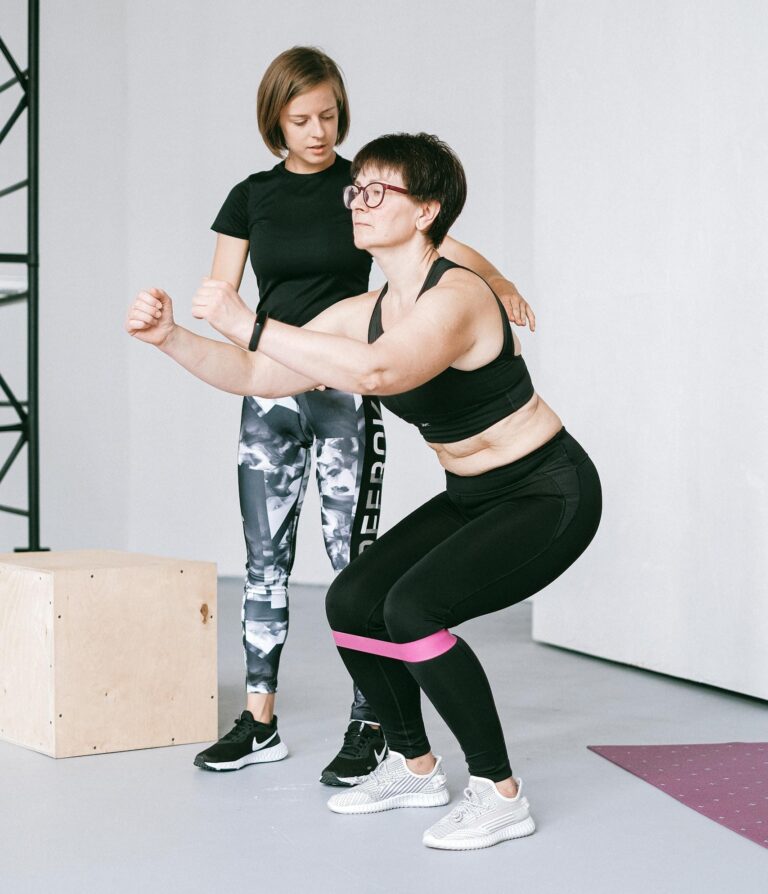 Two women exercising indoors with resistance bands, focusing on balance and fitness. | Doctors Agree: This Is the Best Exercise to Fight Aging and Stay Youthful | Age-Proof Your Balance: 20 Exercises to Stay Steady, Confident, and Fall-Free