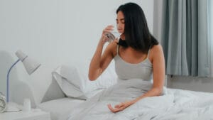woman taking supplement before sleeping | I Took Magnesium and Melatonin Together Every Night—Here’s How It Changed My Sleep | Stop Wasting B12: The One Mistake 90% Make (Here’s When to Take It, Say Experts)