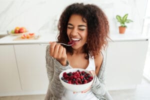 woman eating fruits | The Secret Link Between Gut Health Athletic Performance—Are You Missing Out
