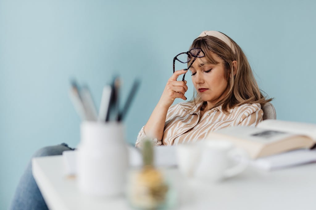 Caucasian woman looks exhausted while taking a break with eyes closed at her desk. | Always Tired? The Vitamin Deficiency Most Adults Have That Steals Your Energy (And How to Fix It!)