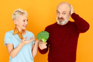 couple holding broccoli | Eat These 6 Foods Daily to Slash Prostate Cancer Risk, Says New Study