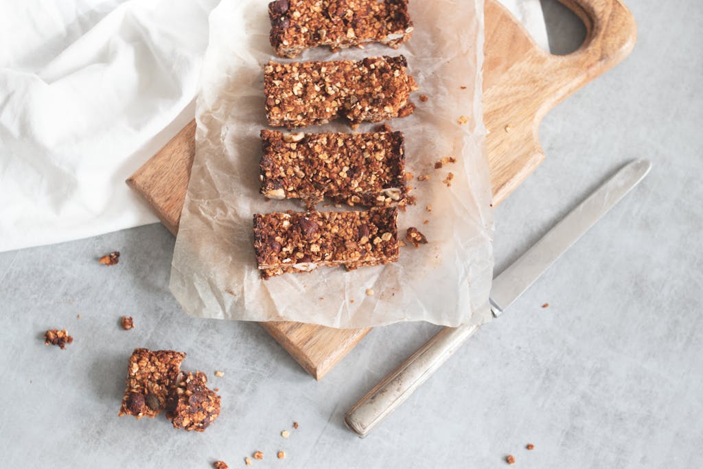 Delicious homemade granola bars on a wooden board, perfect for healthy snacking and meal preparation. | Aging FAST? The 10 "Healthy" Breakfasts SECRETLY Causing Inflammation (Especially After 40!)