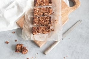 Delicious homemade granola bars on a wooden board, perfect for healthy snacking and meal preparation. | Aging FAST? The 10 "Healthy" Breakfasts SECRETLY Causing Inflammation (Especially After 40!)