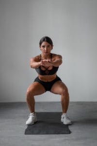 fit woman in squatting position