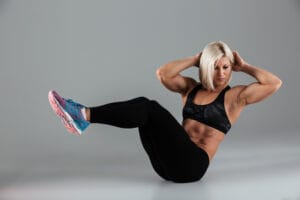 muscular woman doing core workout | Unleash Your Inner Athlete: This Quick 20-Minute Bodyweight Hack Replaces an Hour of Gym GRIND