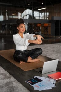 woman stretching at work | STOP Sitting Disease: A Physical Therapist Reveals the ONE Muscle That Will Save Your Hips & Back