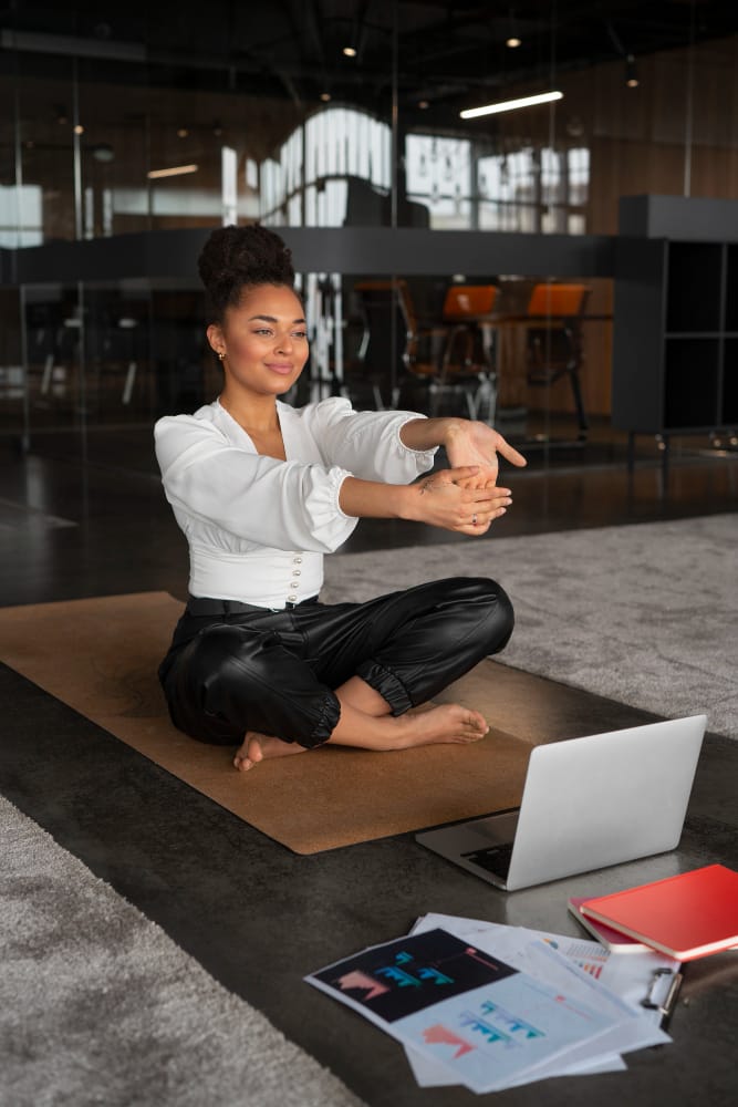 woman stretching at work | STOP Sitting Disease: A Physical Therapist Reveals the ONE Muscle That Will Save Your Hips & Back
