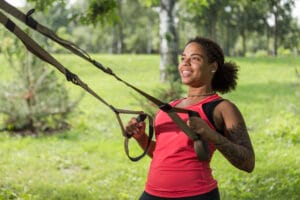 woman using suspension trainer | Personal Trainer: The ONLY At-Home Equipment You Need (Under $50 for HUGE Results!)