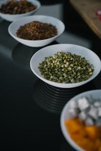 A variety of food bowls featuring mung beans, displayed on a reflective surface. | Protein Powerhouse Carbs? 7 Unexpected Foods That Pack More Protein Than An Egg!