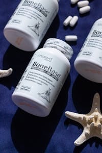 Premium bone and joint supplements with starfish on navy backdrop. | Unlock Max Bone Strength: Scientists Pinpoint The Optimal Time to Take Your Calcium Supplement