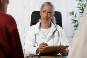 doctor speaking to couple | Tired, Anxious, Cramping? Your Body's 8 Urgent Signs You're Low on Magnesium