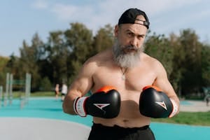 Elderly man engaged in outdoor boxing workout for a healthy lifestyle.