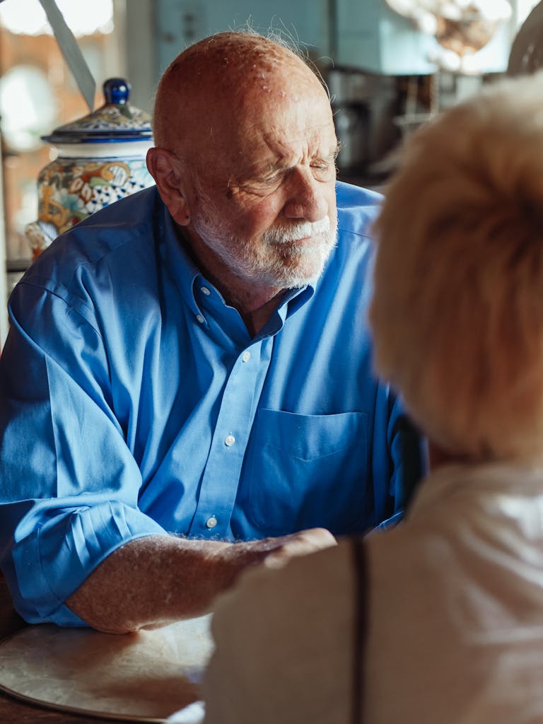 Elderly man in blue shirt in a reflective moment indoors, hinting at nostalgia. | The Forgetful Food List: Are These 10 Brain-Damaging Foods In Your Kitchen?