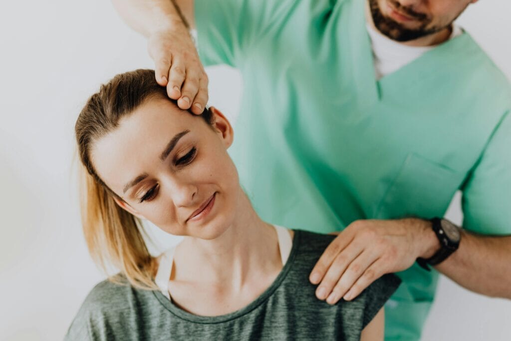Chiropractor treating a female patient for neck pain and posture alignment. | Chiropractor's Secret: 5 Exercises That ERADICATED My Neck Hump & Fixed My Posture! (My Results)
