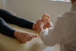 Close-up of a foot massage therapy session with a therapist working on a client's foot. | Is This Foot Sensation a Red Flag? It Could Be an Early Warning of Diabetes