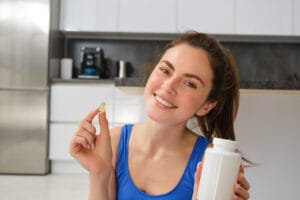 young woman taking vitamins | Doctors Say: This is the Best Time to Take Vitamin C Supplements for Maximum Benefits (Morning on an Empty Stomach)