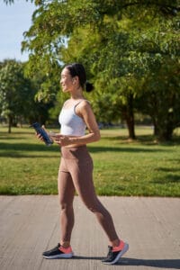 asian woman in fitness gear walking | Harvard-Backed Japanese Walking Method That Balances Blood Sugar and Pressure Naturally