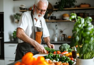 elderly man chopping vegetables | 10 Powerful Plant Proteins That Can Replace Meat—Plus 3 Nutrients You Might Be Missing