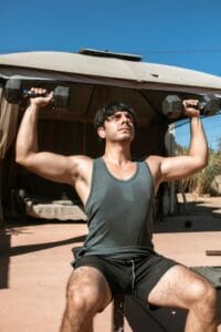 man doing dumbbell shoulder press | Build Lean Muscle After 40: These 8 Moves Are Your Secret Weapon Against Aging