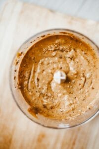 Top view of homemade brown nut butter in a blender, showcasing a healthy and nutritious breakfast option. | Homemade High-Protein Cookie Butter