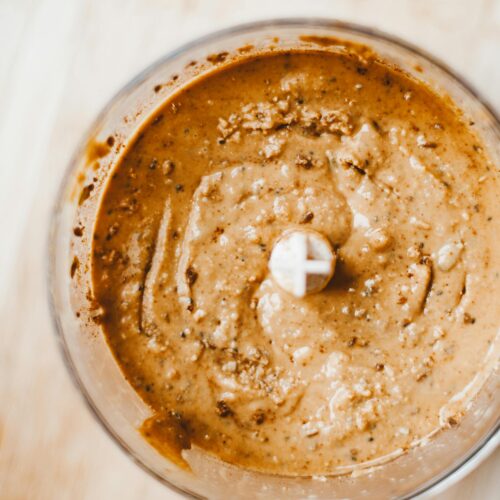 Top view of homemade brown nut butter in a blender, showcasing a healthy and nutritious breakfast option. | Homemade High-Protein Cookie Butter
