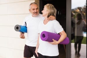 senior couple exercising in a garden | Over 60 and Fitter Than Most 30-Year-Olds—This Couple’s At-Home Routine Is Shocking Trainers