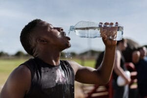 thirsty man drinking a bottle of water | Think Drinking More Water Is Always Healthy? It Could Be Wrecking Your Digestion