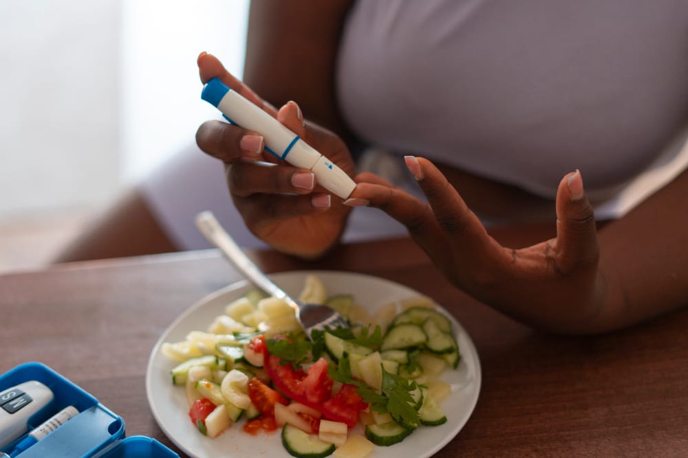 woman checking glucose levels | Why So Many People With Diabetes Struggle to Exercise—And How to Break Through