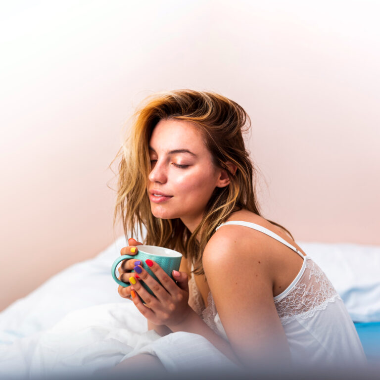 woman drinking tea before bed | Can’t Sleep? These 10 Natural Alternatives to Melatonin Actually Work